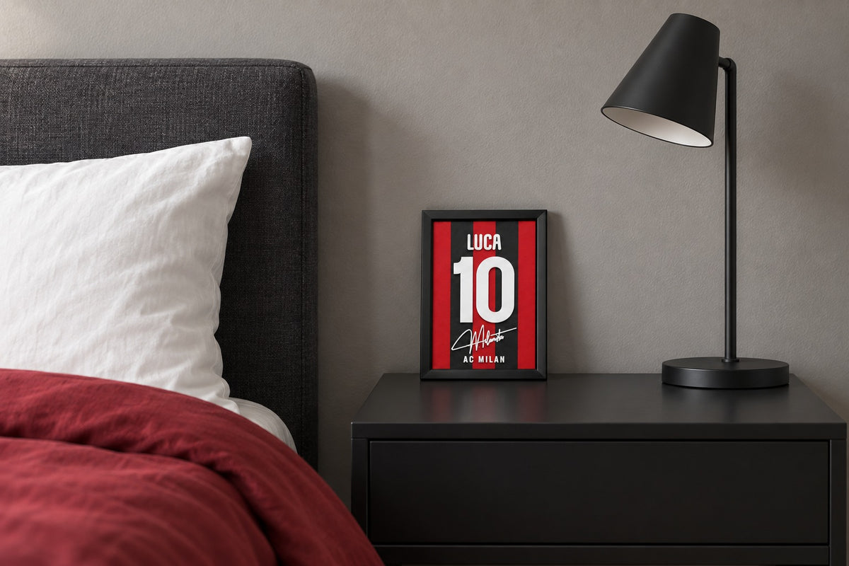 AC Milan jersey frame personalized with LUCA on a bedside table beside a black lamp and a red duvet.