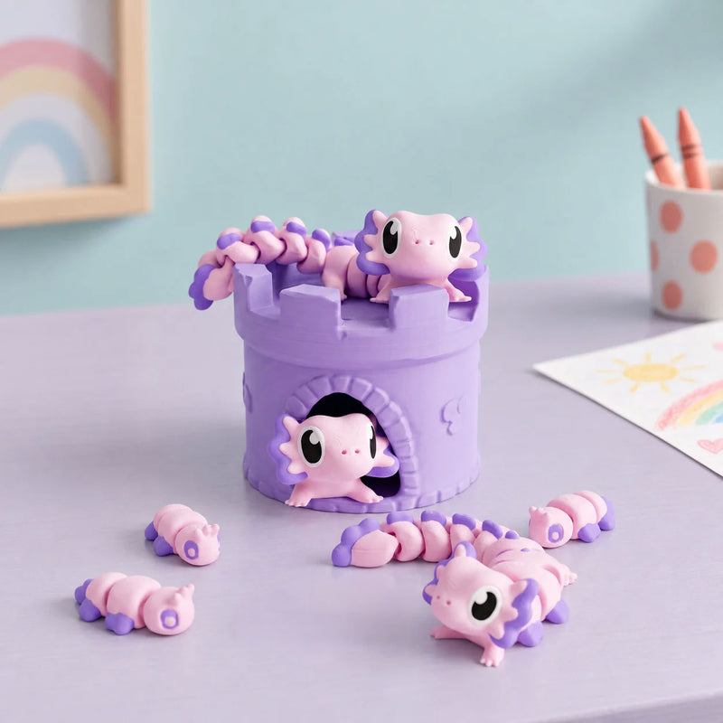 Pink and purple articulated axolotls arranged around a purple castle in a styled home setting.