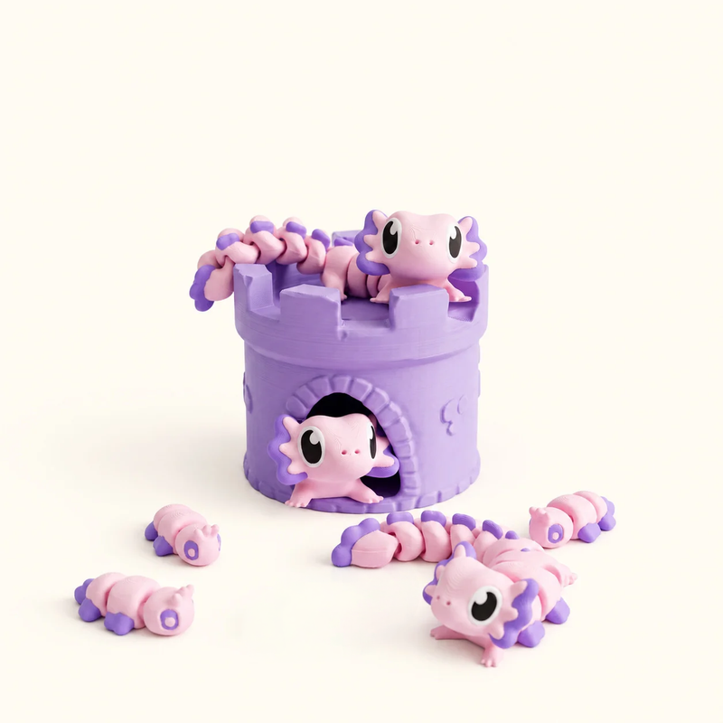 Pink and purple articulated axolotls arranged around a purple castle on a soft white background.