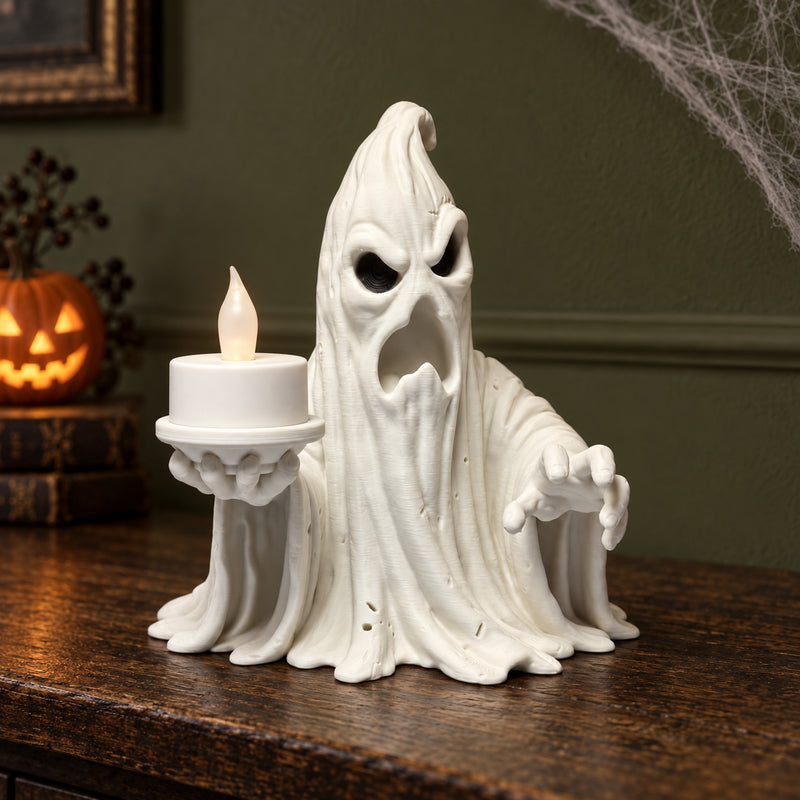 White draped ghost holding a white LED tealight on a raised platform in a styled home setting.
