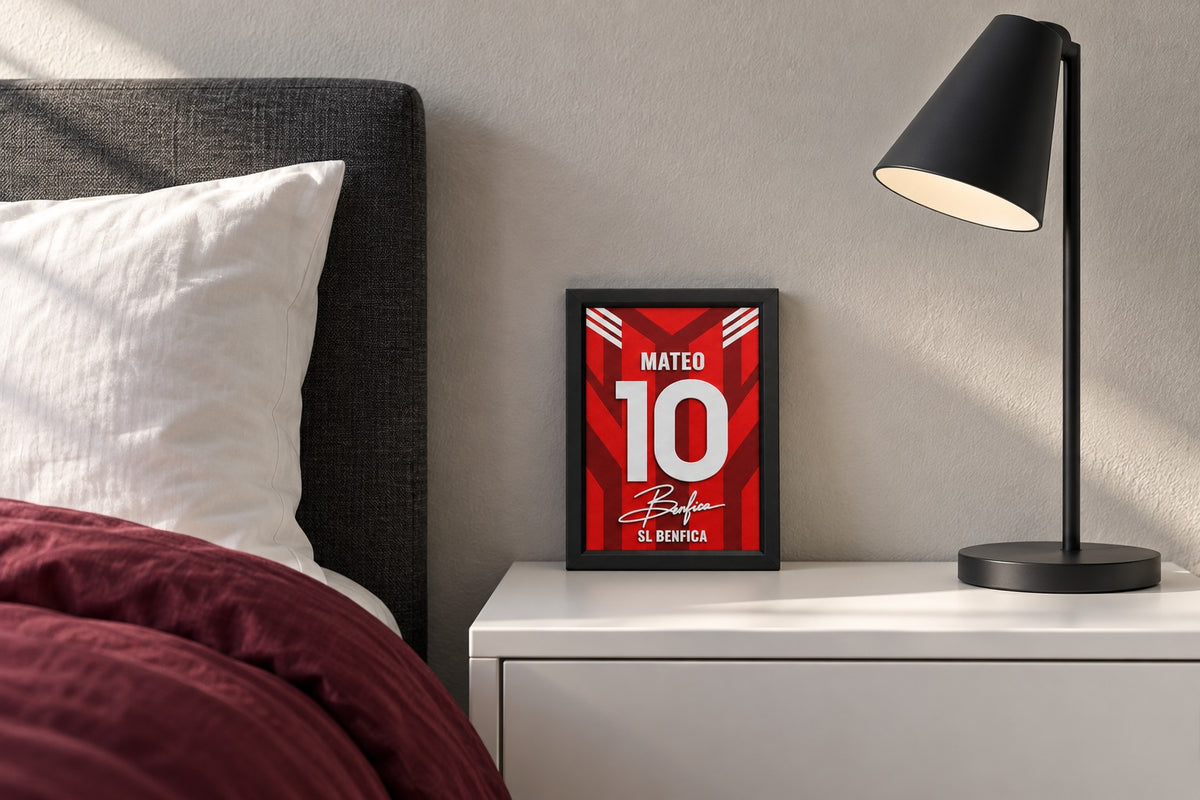 Benfica jersey frame personalized with MATEO on a bedside table beside a black lamp and a red duvet.