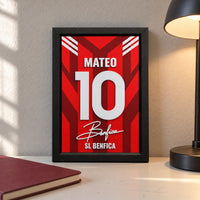 Benfica jersey frame personalized with MATEO and the number 10, standing on a desk beside a black lamp and a red notebook.