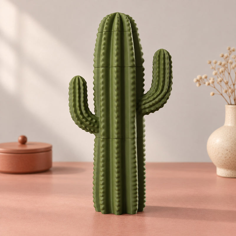 Tall green ribbed cactus decoration with two upright arms in a styled home setting.