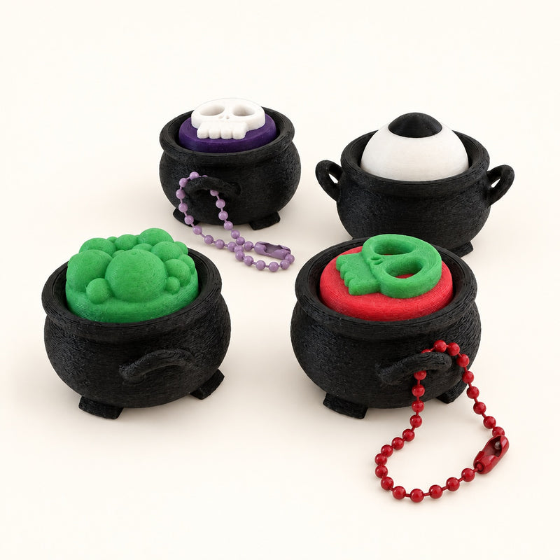 Halloween Cauldron Clickers on a warm ivory background.