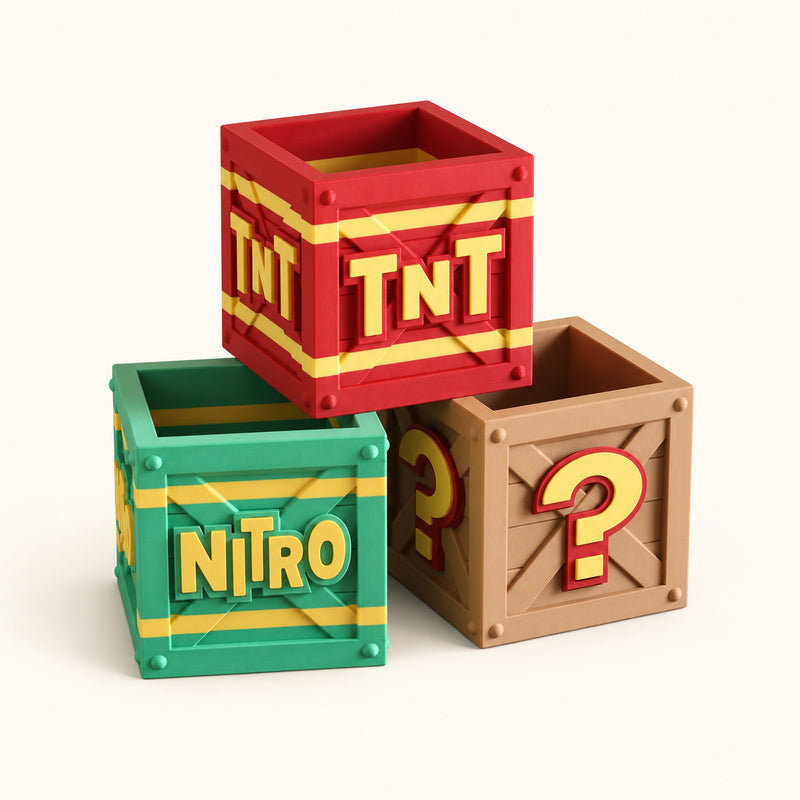 Red TNT, green NITRO and brown question-mark miniature crates on a soft white background.