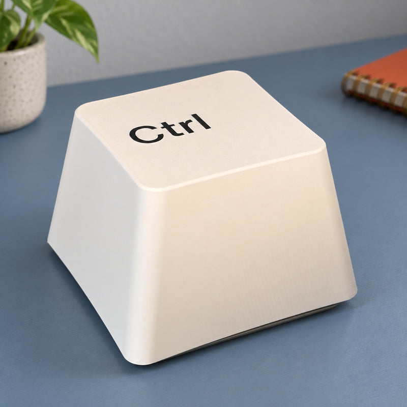White table lamp shaped like an oversized Ctrl keyboard key in a styled home setting.