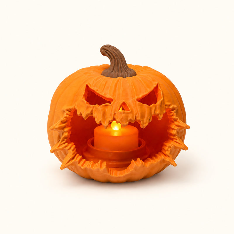 Orange pumpkin lantern with a jagged burst-open mouth and warm light inside on a soft white background.