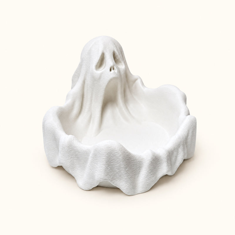 White ghost-shaped bowl with draped sides and an open front compartment on a soft white background.