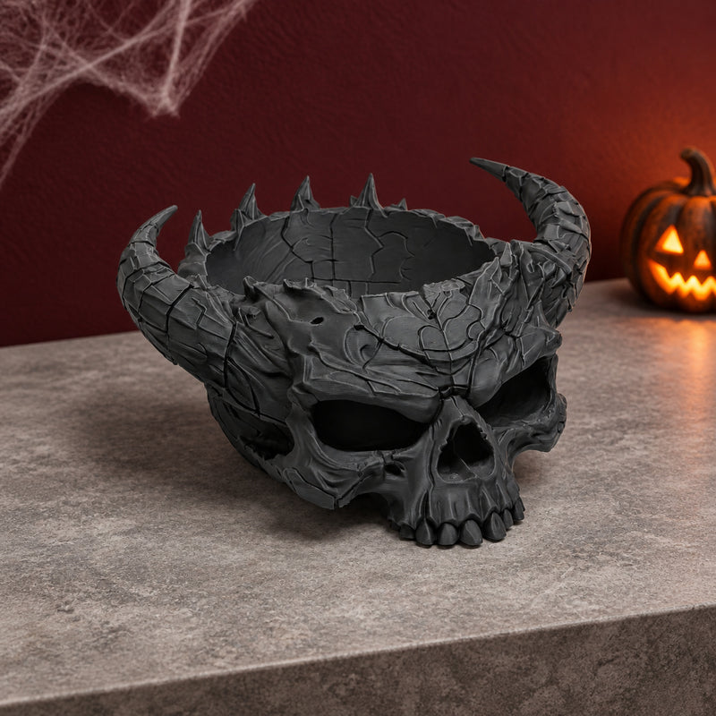 Black horned skull bowl with a textured surface and open top in a styled home setting.