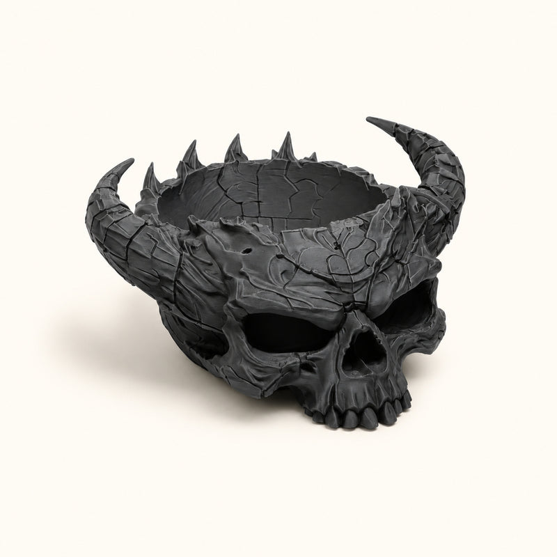 Black horned skull bowl with a textured surface and open top on a soft white background.