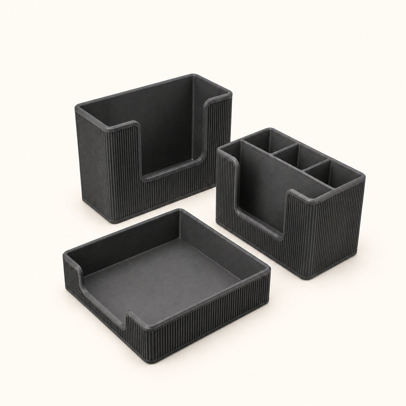 Three black rectangular dining organizers including a shallow tray and upright holders on a soft white background.