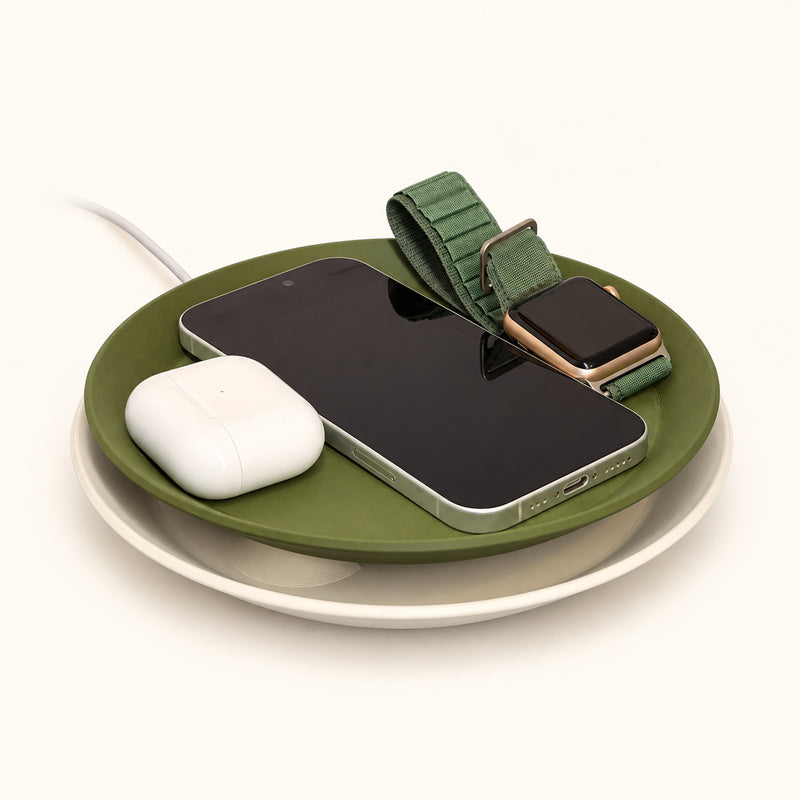 Olive and cream round tray lamp holding a phone, watch and white earbud case on a soft white background.