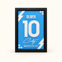 Manchester City jersey frame personalized with OLIVER and the number 10 on a soft white background.