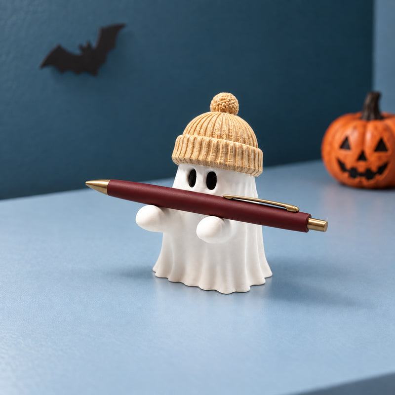 White ghost pen holder in a beige toque supporting a burgundy pen in a styled home setting.
