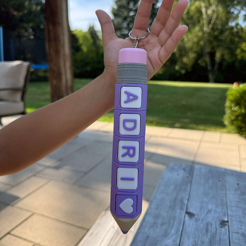 Pencil-shaped Adri clicker with colourful letter and icon blocks