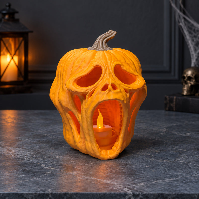 Orange screaming pumpkin lantern with an elongated open mouth in a styled home setting.