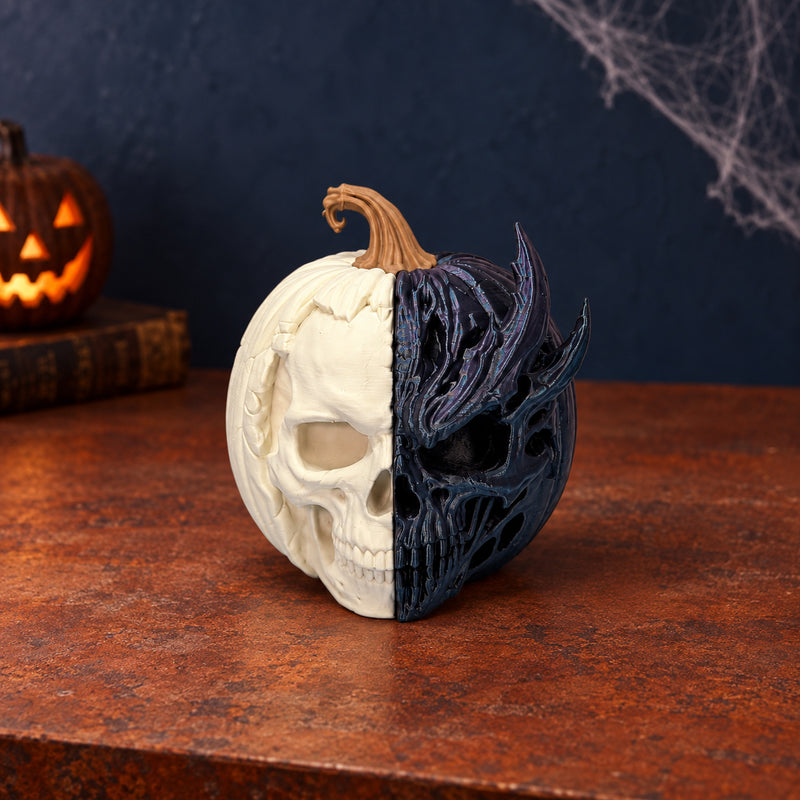 Pumpkin decoration split between a pale skull and a dark detailed skull face in a styled home setting.