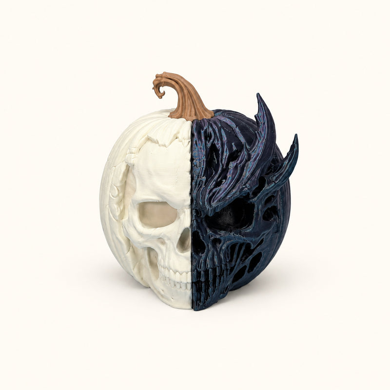 Pumpkin decoration split between a pale skull and a dark detailed skull face on a soft white background.