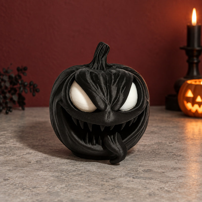Black pumpkin with pale eyes, pointed teeth and a wide grin in a styled home setting.