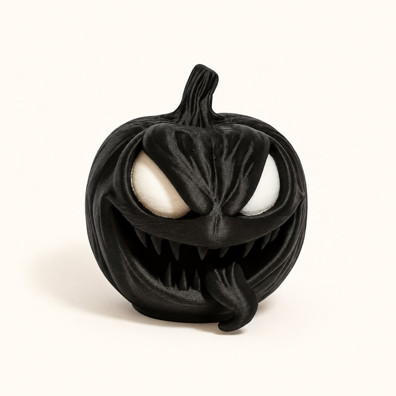 Black pumpkin with pale eyes, pointed teeth and a wide grin on a soft white background.