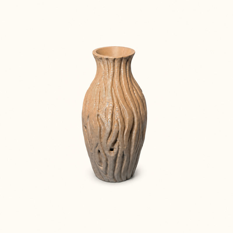 Tan decorative vase with flowing wood-like grooves and a flared neck on a soft white background.